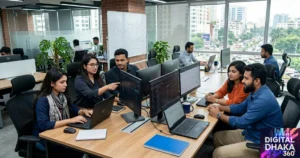 A Digital Dhaka 360 image featuring a team of men and women working together on SEO tasks at computers.